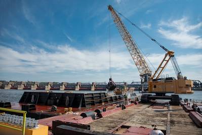 Rock Island District's local maintenance crew from the Mississippi River Project Office in Pleasant Valley, Iowa, performs mechanical dredging with a three-yard crane bucket mounted on a barge in Pool 16. (Photo: Kelcy Hanson / USACE)