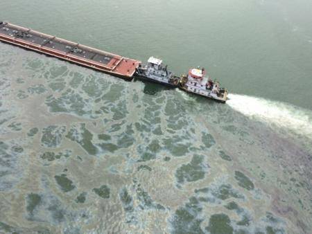 A barge loaded with marine fuel oil sits partially submerged in the Houston Ship Channel, March 22, 2014.